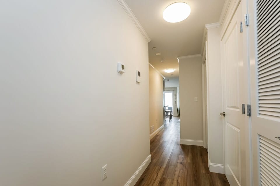 Hallway with stackable washer dryer in the closet - 405 Old Wharf Road-Dennisport Cape Cod- New England Vacation Rentals
