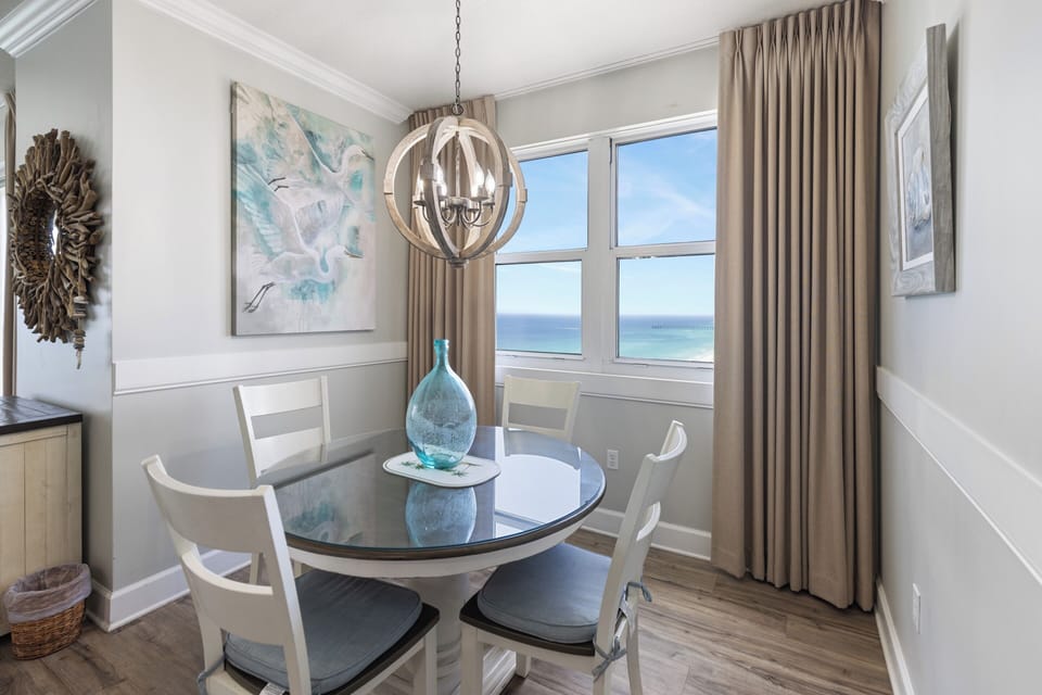 Savor your morning coffee at this charming dining table while gazing at stunning ocean views that stretch endlessly across the horizon—a perfect spot to plan your daily adventures.