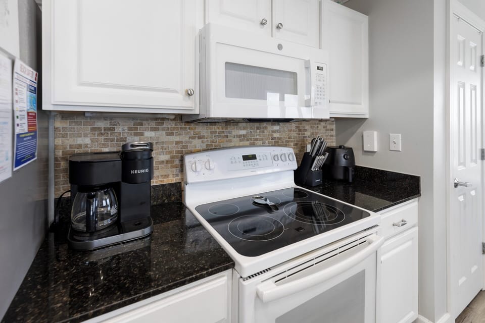 Your fully equipped kitchen features granite countertops, modern appliances, and everything you need to prepare meals during your stay, from coffee makers to a complete knife set.