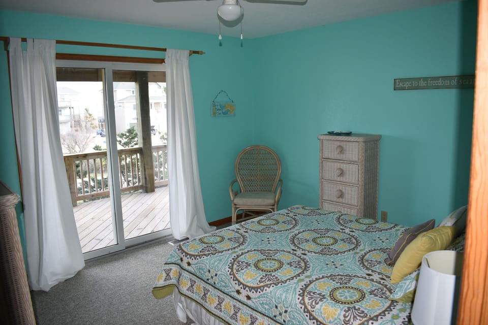 Queen Bedroom on 1st level access to ocean view deck and shared full bath.