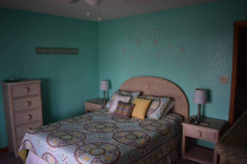 Queen Bedroom on 1st level, access to ocean view deck and shared full bath.