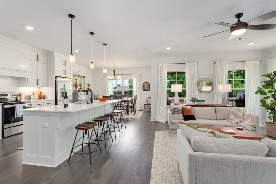 The Solitude Retreat is a brand-new home featuring a modern, open floor plan with tons of seating, a fully stocked kitchen with island, 4-burner stove top, and a dining table that can seat 7.