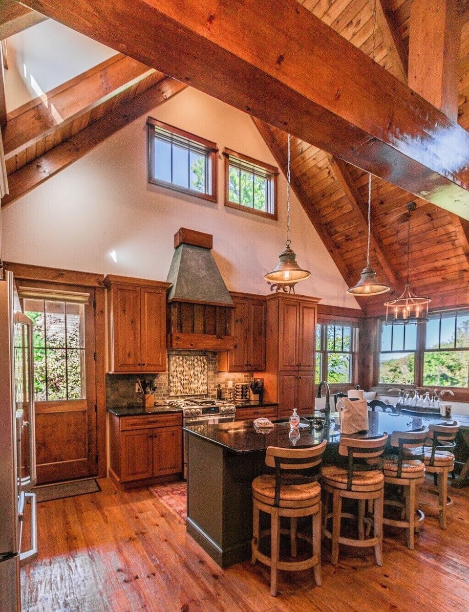 The kitchen, dining, and living areas have high vaulted ceilings