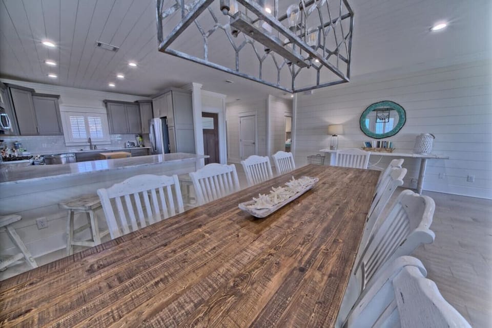 Gather loved ones in this thoughtfully designed kitchen and dining space, where culinary creation meets elegant coastal comfort.