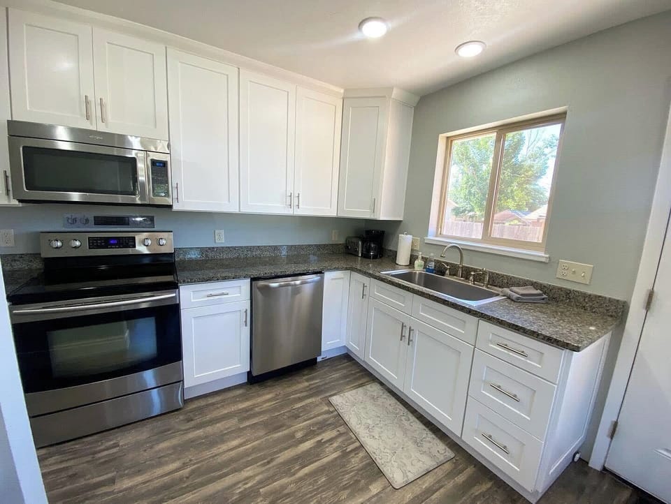 Enjoy the convenience of a fully stocked kitchen featuring stainless steel appliances, granite countertops, and everything you need to cook at home.