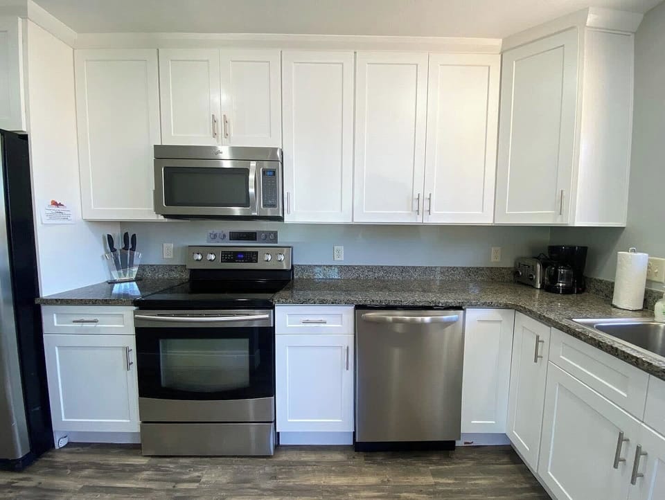 Cook, gather, and connect in the bright, modern kitchen featuring full-size appliances and plenty of space for meal prep.