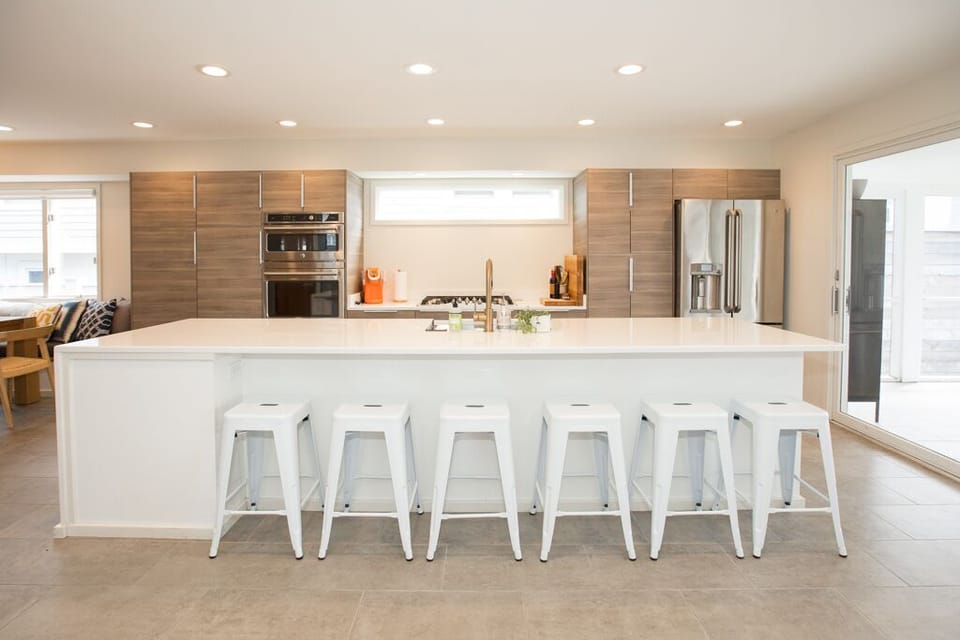 Kitchen island seats six opens to dining room and main living area