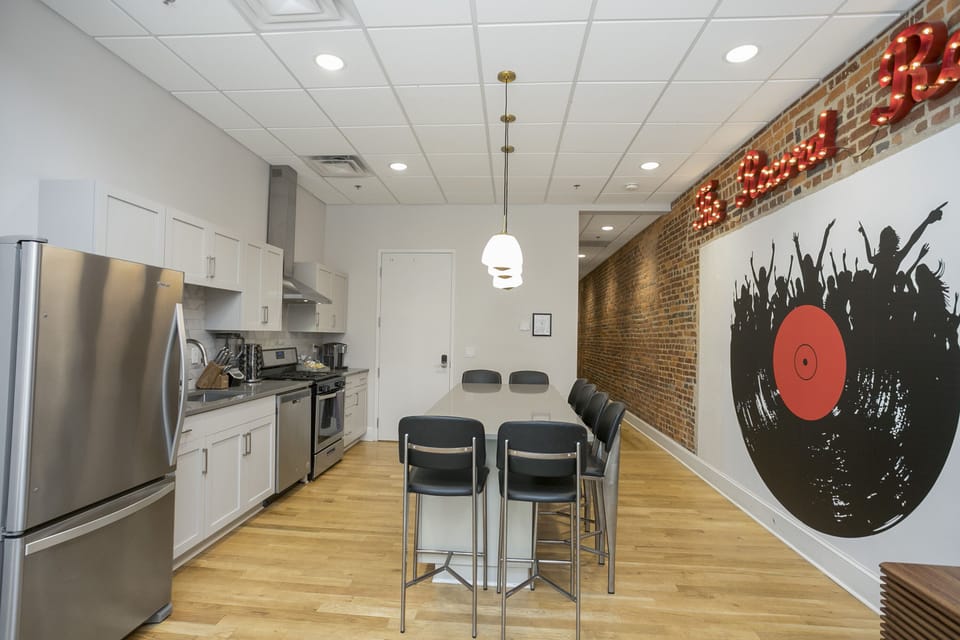 - Kitchen area with modern appliances and pendant lighting   - Large island provides comfortable seating and gathering space   - Clean bright layout ideal for extended stays and group trips