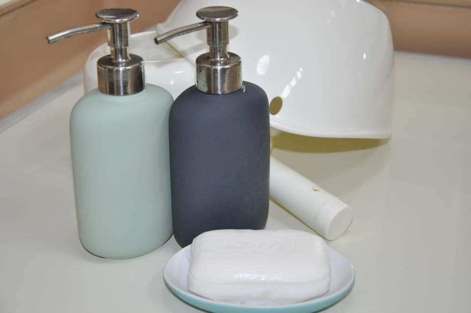 Shower, hair dryer, slippers, towels