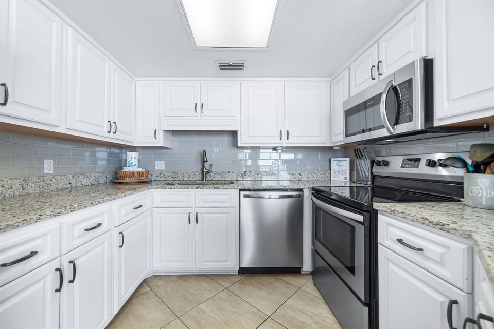 Fully equipped kitchen with granite countertops, modern amenities, and an unbeatable ocean backdrop. Culinary inspiration guaranteed.