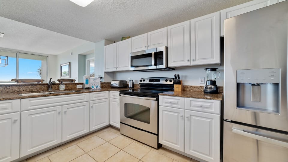 This bright and airy kitchen offers ample counter space, modern cabinetry, and stunning views, perfect for cooking and entertaining.