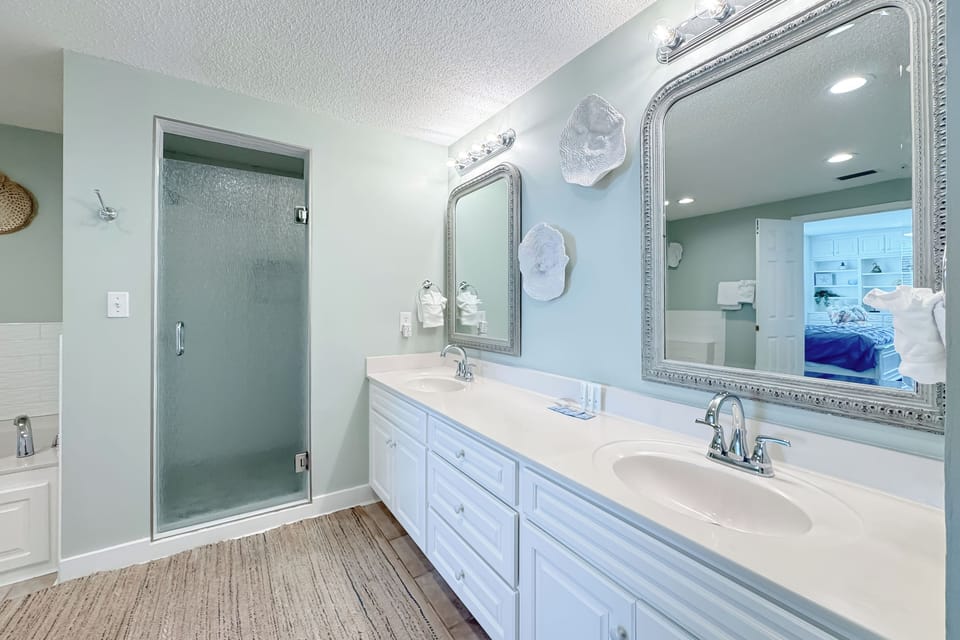 This well-lit bathroom offers double vanity, ample space, and essential amenities.  A clean and inviting retreat.