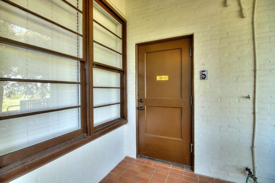 Your private entrance welcomes you with charming details—wood-framed windows flood the space with natural light while classic tile flooring adds authentic character.