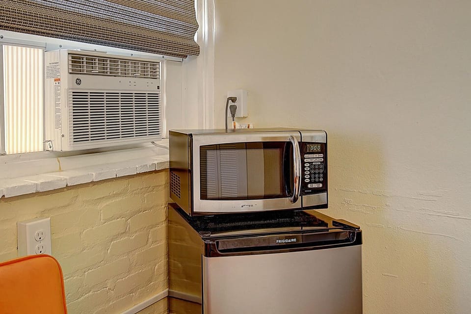 Your kitchenette features modern appliances including a microwave and mini-fridge, plus refreshing air conditioning for comfortable cooking and dining.