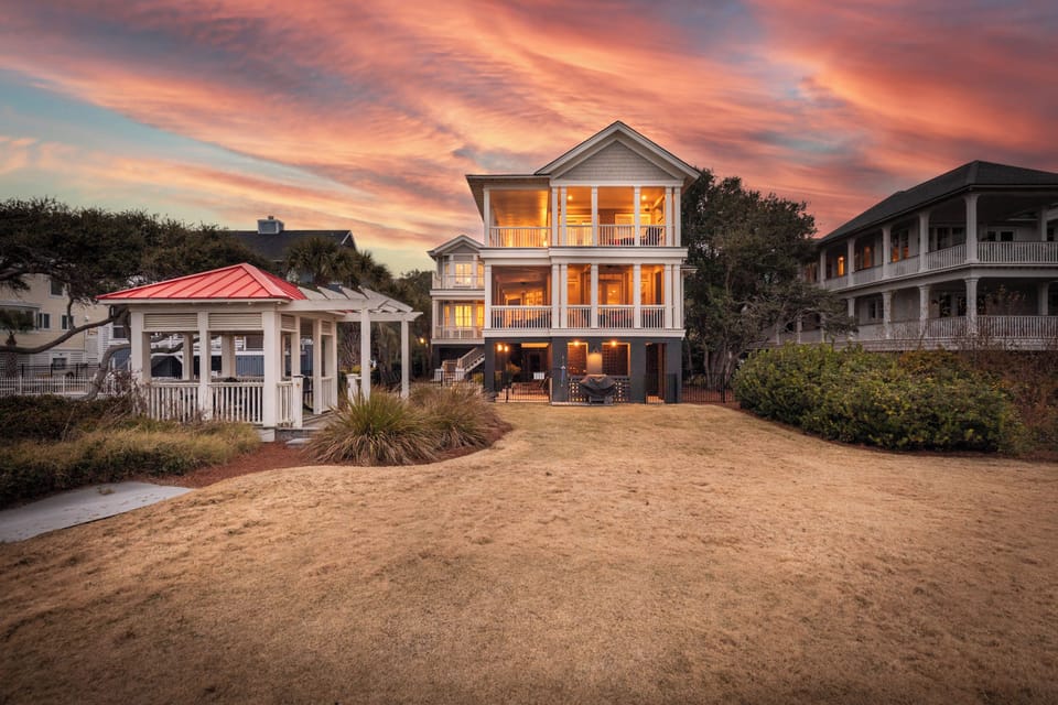 Breathtaking oceanfront home glowing at sunset, just steps from the pristine Isle of Palms beach