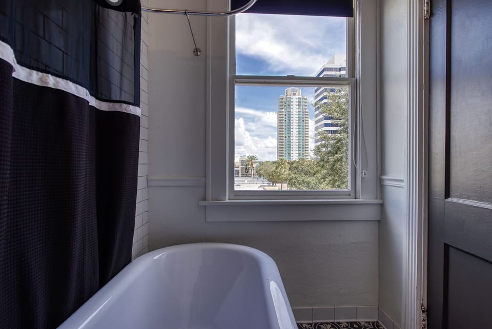 Shower, designer toiletries, hair dryer, towels