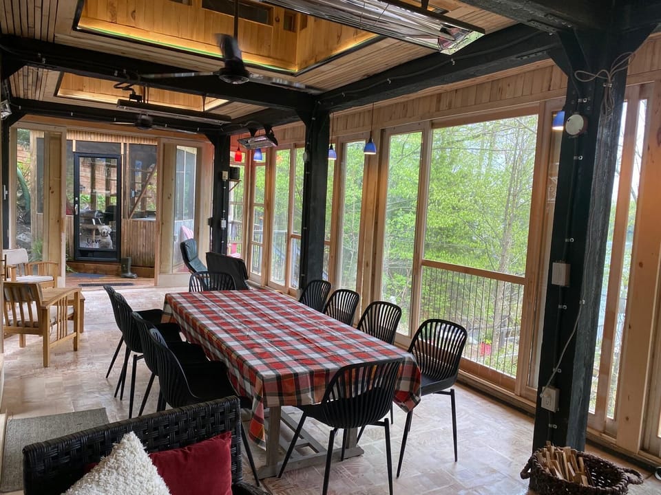 Group seating in spacious veranda with a glorious view of Grand Lake