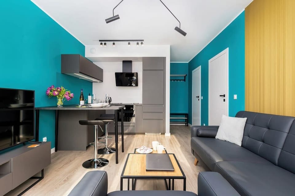 A slightly different angle of the kitchen, showing the sleek cabinetry and compact appliances.