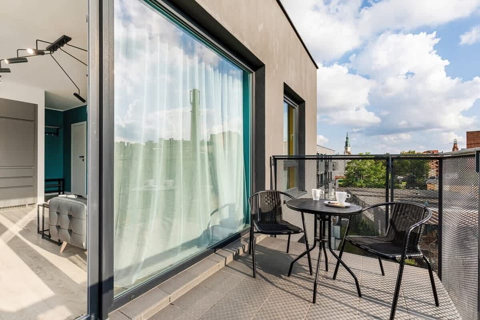 The outdoor balcony again, with a view of the glass sliding doors leading back inside.