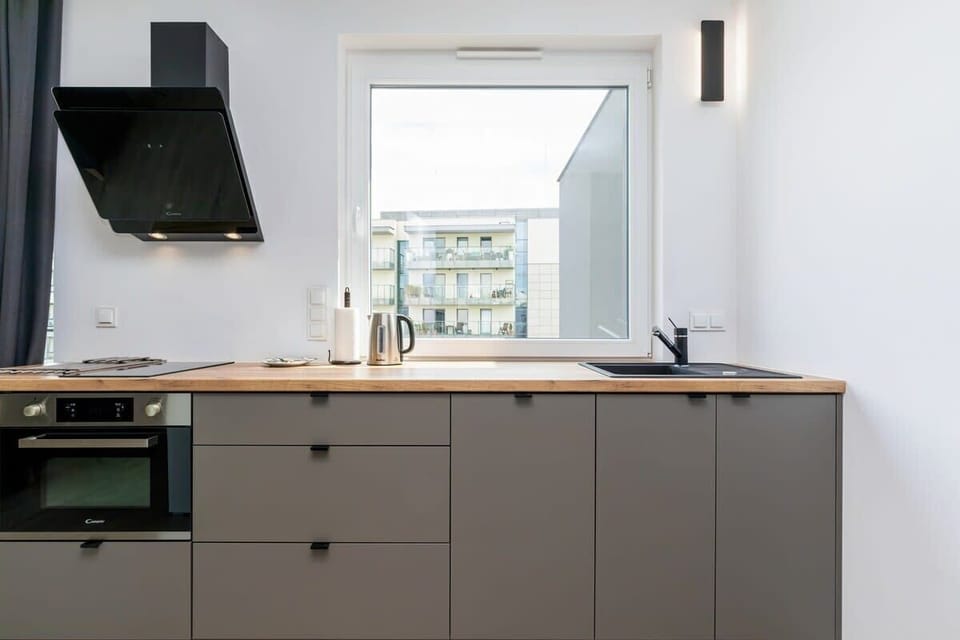 The sleek design of the kitchenette blending seamlessly with the living area.