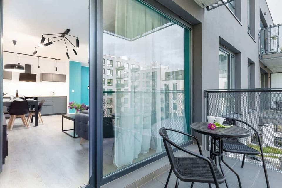 Spacious balcony with outdoor furniture. 