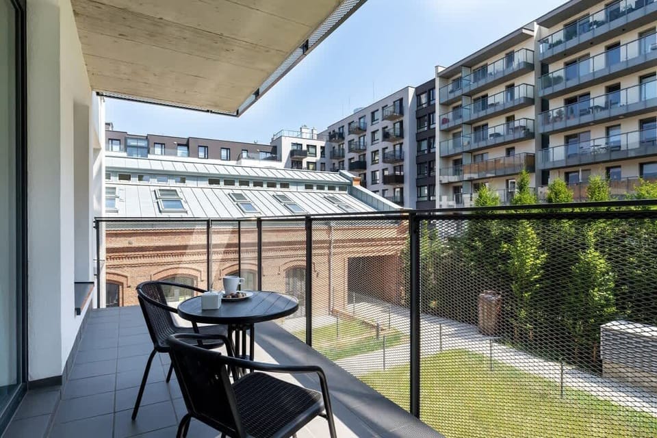 The furnished balcony offers a perfect spot for morning coffee with a view.