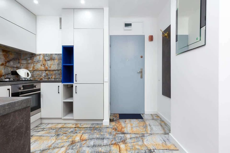 Kitchenette with oven and refrigerator. 