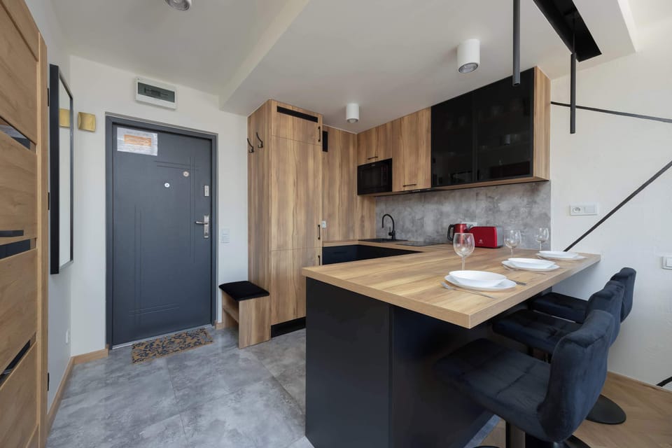 Modern kitchen with dining bar and stools.