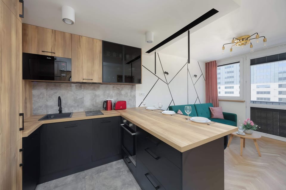 Open-plan kitchen and living area with breakfast bar.