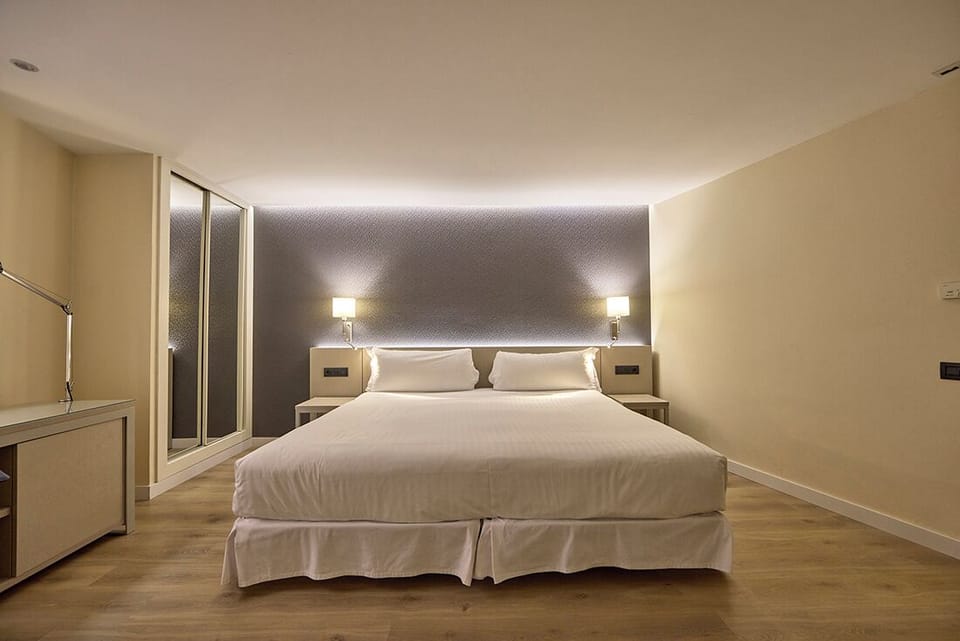 Family Quadruple Room | Minibar, in-room safe, desk, blackout drapes