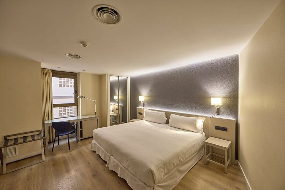Family Quadruple Room | Minibar, in-room safe, desk, blackout drapes