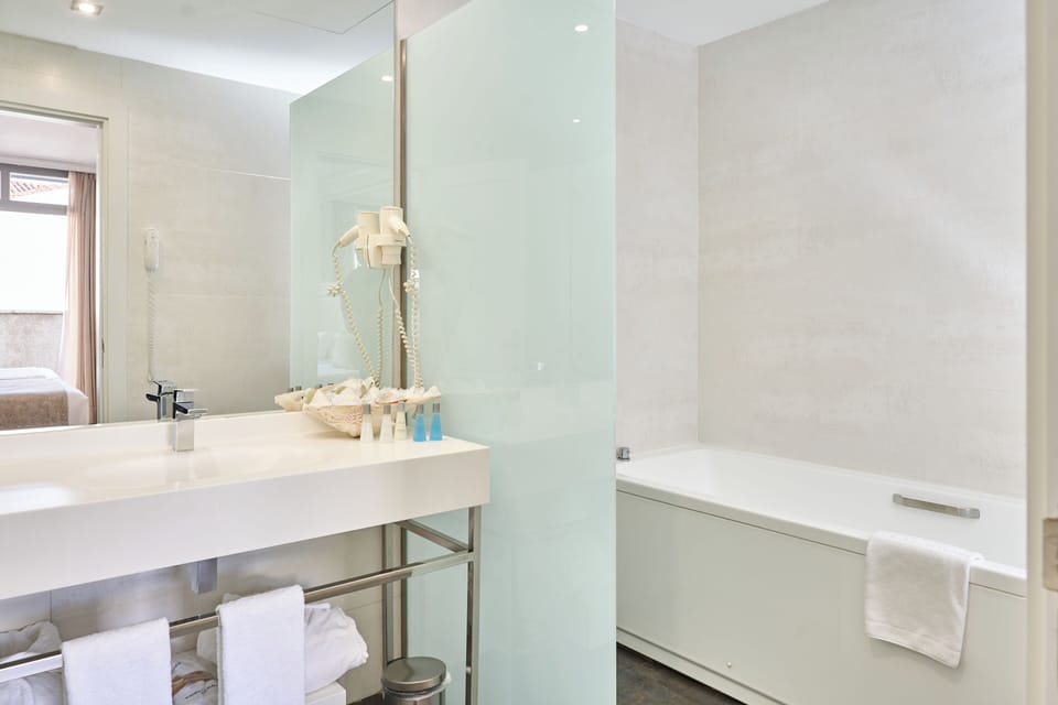 Deep soaking tub, designer toiletries, hair dryer, bidet