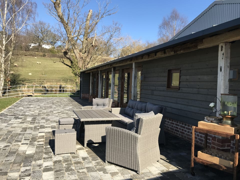 The Byre's terrace next to the pond (Olly Knight Photography)