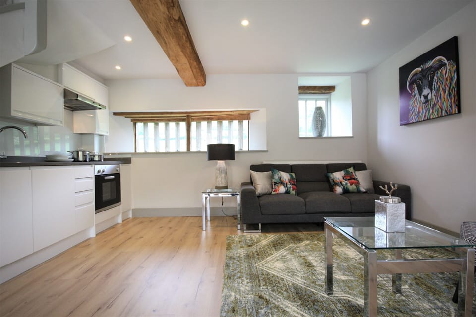 Open plan living area with a sofa and two tub chairs