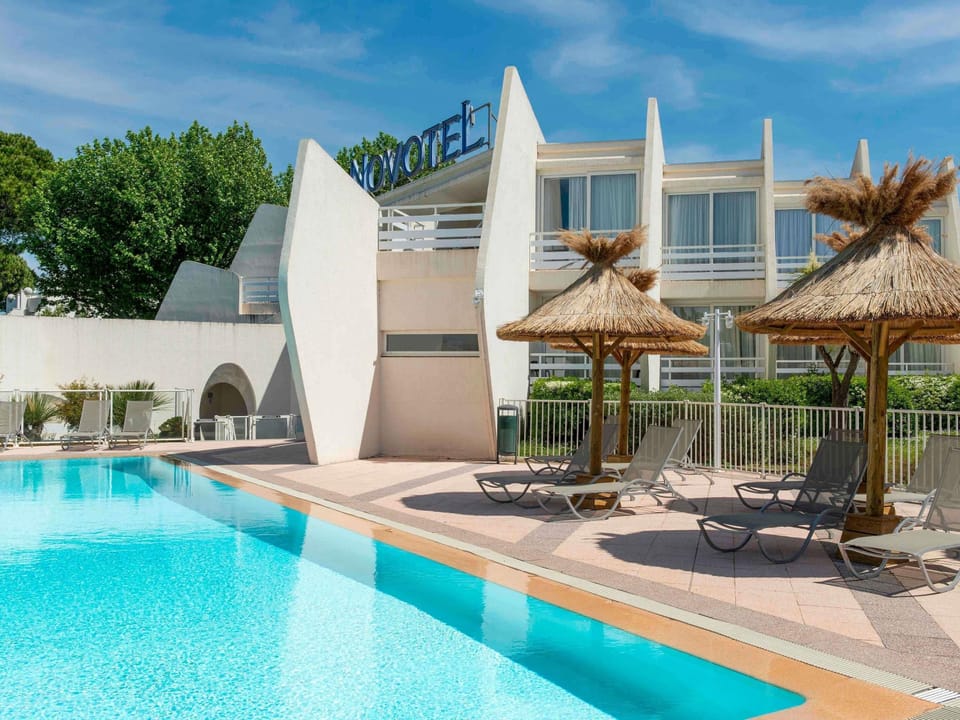 Seasonal outdoor pool, open 9:00 AM to 9:00 PM, pool umbrellas
