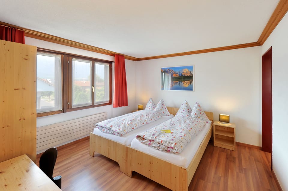 Desk, blackout drapes, bed sheets, alarm clocks
