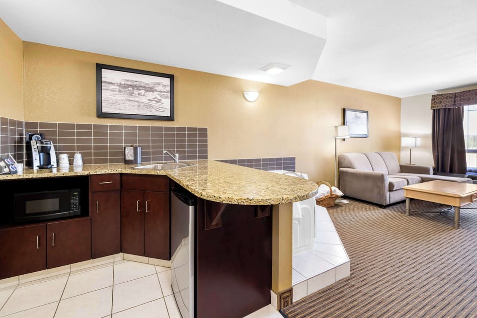 Suite, 1 King Bed, Non Smoking, Jetted Tub (Separate Living Room) | Desk, laptop workspace, blackout drapes, iron/ironing board