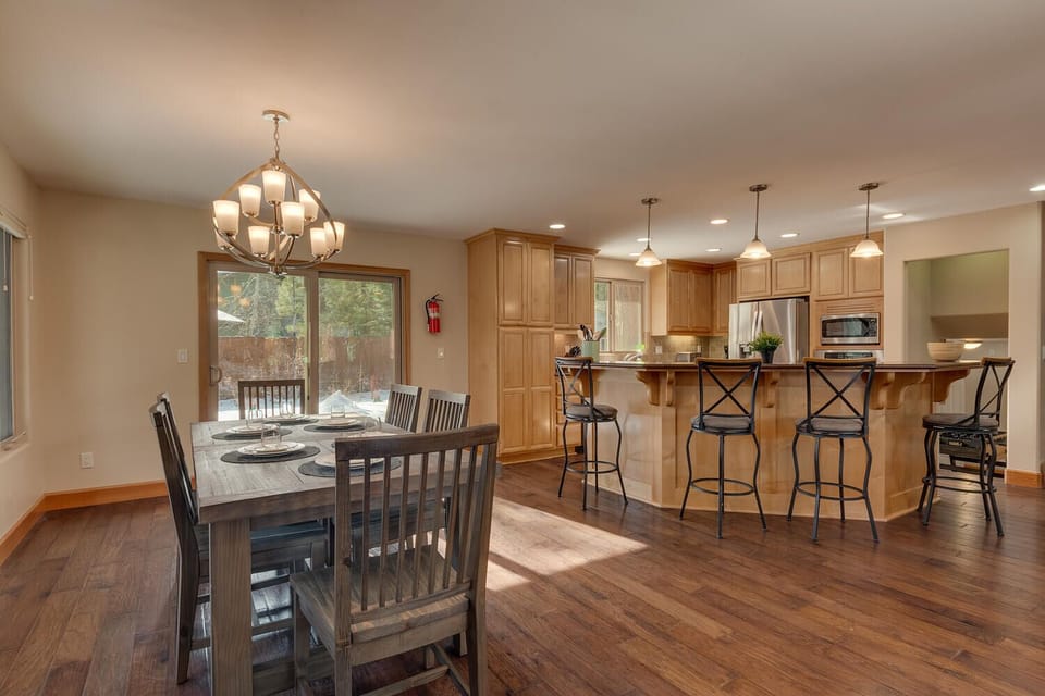 - Bright dining area with natural sunlight views  
- Rustic wood table set for family and friends  
- Connected to kitchen for seamless group dining