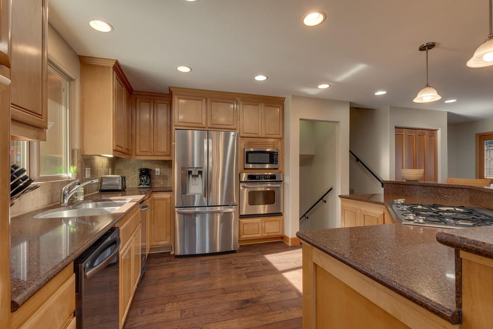 - Fully equipped kitchen with stainless steel fridge  
- Double ovens and microwave for easy meal prep  
- Ample counter space designed for group cooking