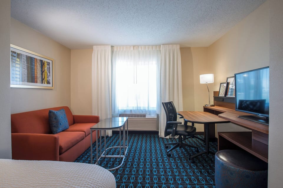 Suite, Multiple Beds | Living area | 36-inch Smart TV with cable channels, TV, Netflix