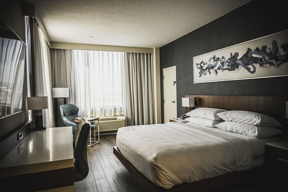 Desk, laptop workspace, blackout drapes, iron/ironing board