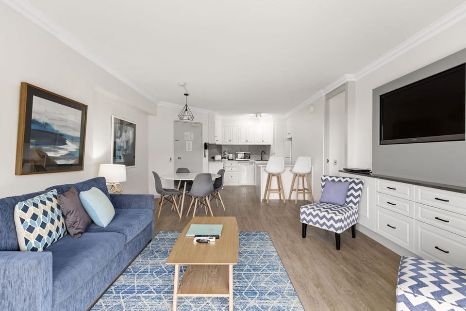 Deluxe One Bedroom Apartment | Living area | 32-inch TV with satellite channels