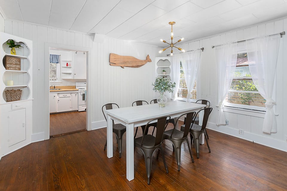 Dining room with kitchen in background