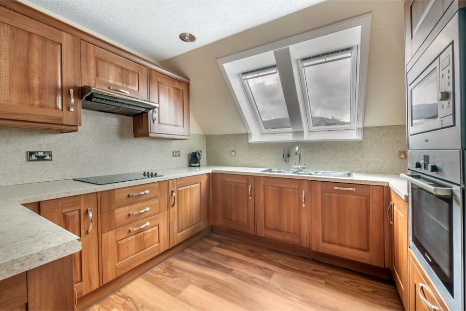 Traditional wooden kitchen, fully equipped for home-style cooking.
