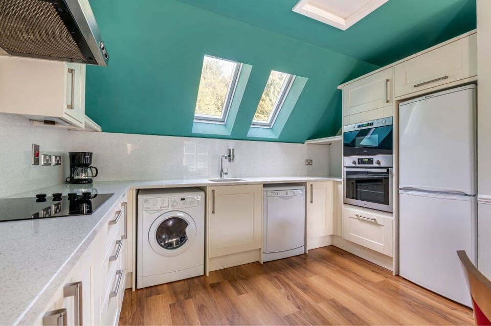 Compact and efficient kitchenette with skylights for a bright cooking space.