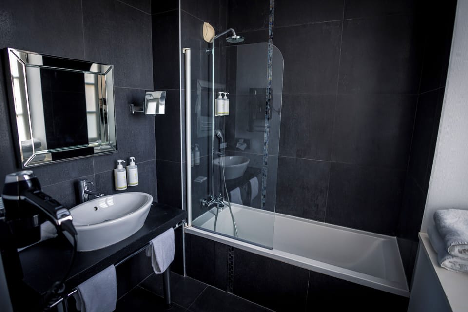 Prestige Room | Bathroom | Designer toiletries, hair dryer, slippers, towels