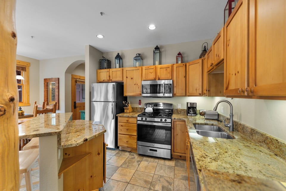 The kitchen features granite countertops and stainless steel appliances.