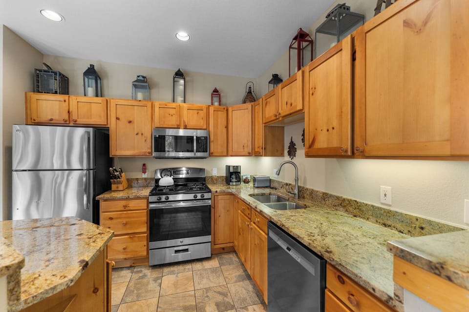 The kitchen features granite countertops and stainless steel appliances.