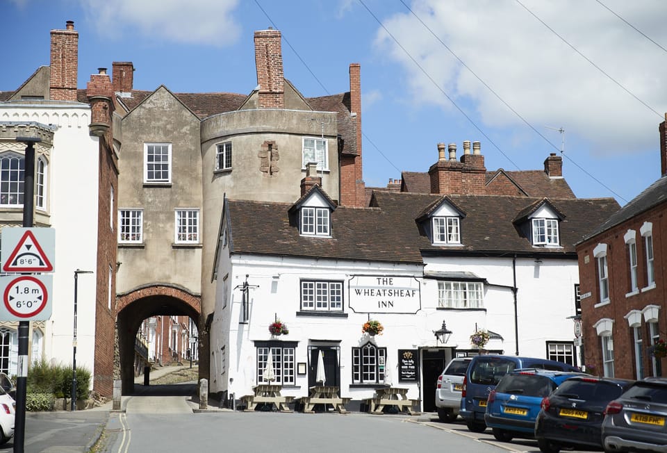 Ludlow's Broad Street, with the Buttercross at the top and the town wall gatehouse at its foot