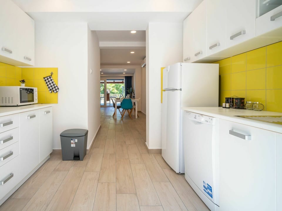 Room, Yellow, Property, Interior Design, Floor, Kitchen, Building, Cabinetry, Ceiling, Furniture